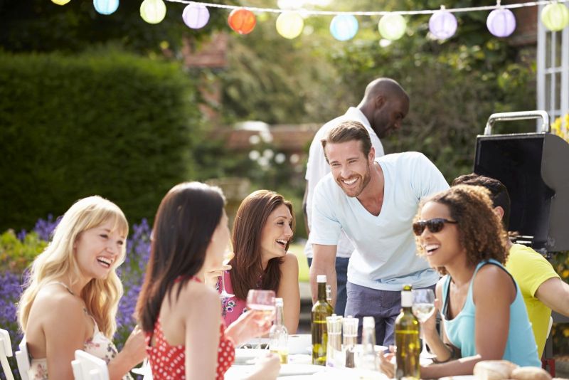 Group Of Friends Having Outdoor Barbeque At Home