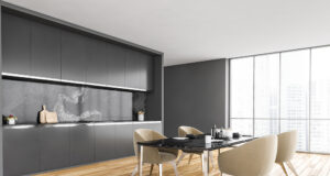 Black And White Minimalist Kitchen, Black Table And Beige Chairs Near Window With City View, Side Vi