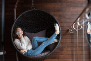 Beautiful,happy,girl,dressed,in,white,sweater,and,blue,jeans